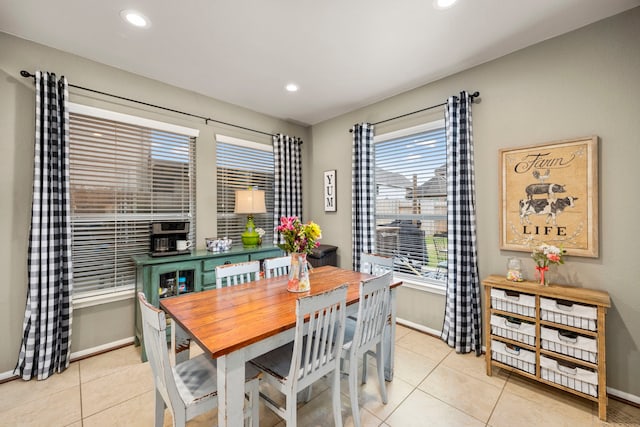 dining room featuring light tile patterned floors and baseboards