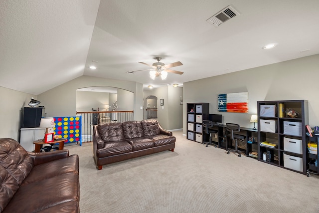 living area featuring lofted ceiling, ceiling fan, light carpet, and visible vents