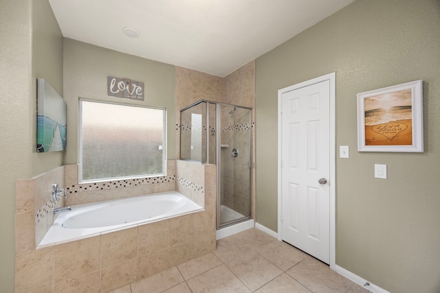 full bathroom with a stall shower, tile patterned flooring, and a bath