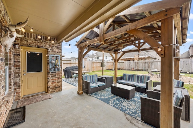 view of patio / terrace with a fenced backyard, an outdoor living space, and grilling area