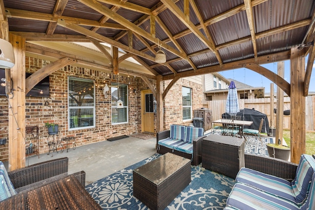 view of patio with fence, an outdoor living space, a ceiling fan, a gazebo, and grilling area