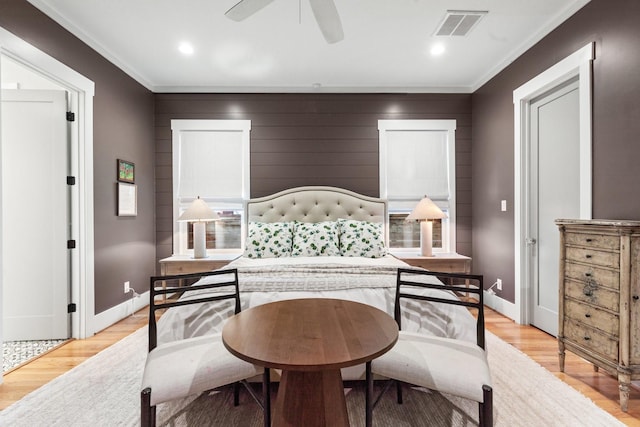 bedroom with a ceiling fan, visible vents, light wood-style flooring, and baseboards