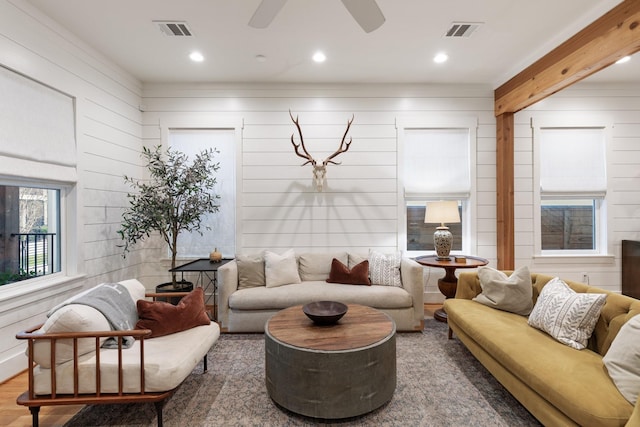 living room featuring wood finished floors, visible vents, and recessed lighting