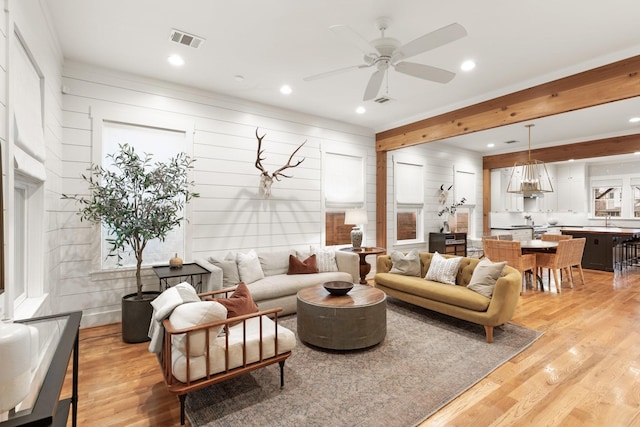 living area featuring ceiling fan, light wood-type flooring, visible vents, and recessed lighting