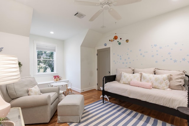 living area featuring wood finished floors, a ceiling fan, visible vents, vaulted ceiling, and baseboards