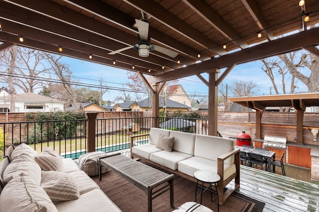 wooden terrace with a fenced backyard, an outdoor hangout area, a ceiling fan, grilling area, and a residential view