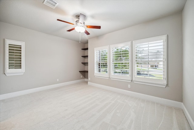 unfurnished room featuring baseboards, ceiling fan, visible vents, and light colored carpet