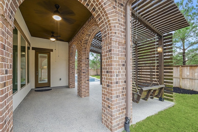 view of patio / terrace featuring ceiling fan and fence