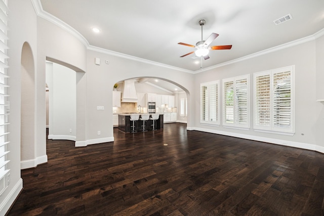 unfurnished living room with baseboards, crown molding, visible vents, and dark wood-style flooring