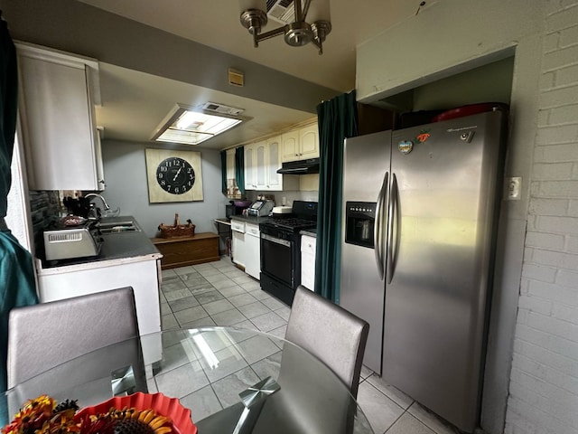 kitchen with black range with gas cooktop, stainless steel fridge, under cabinet range hood, white cabinetry, and a sink