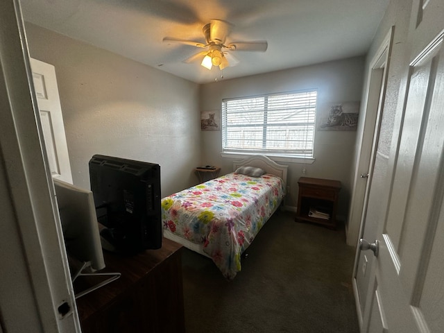 bedroom with a ceiling fan and dark colored carpet