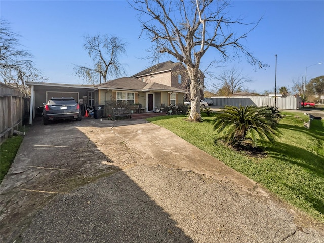 view of front of property with concrete driveway, fence, a front lawn, and an attached garage