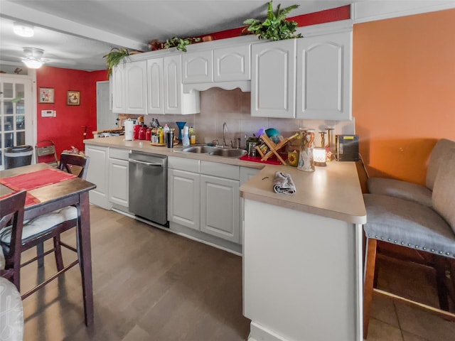 kitchen with light countertops, light wood-style flooring, white cabinets, a sink, and dishwasher