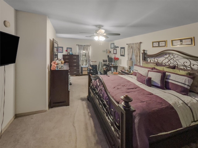 carpeted bedroom featuring ceiling fan and baseboards