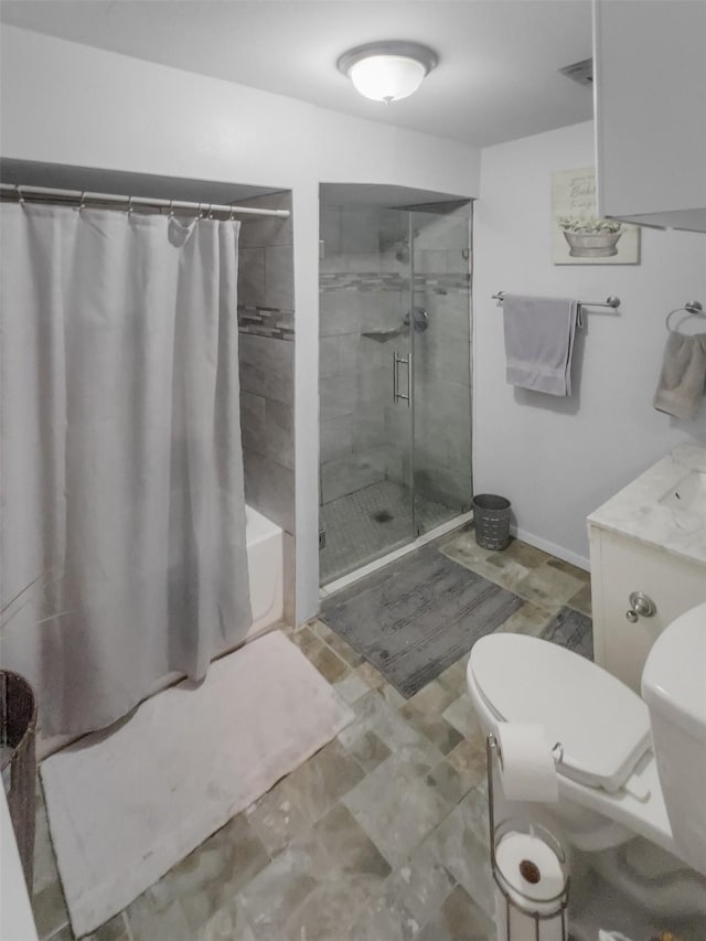 bathroom with a tub, tiled shower, toilet, and baseboards