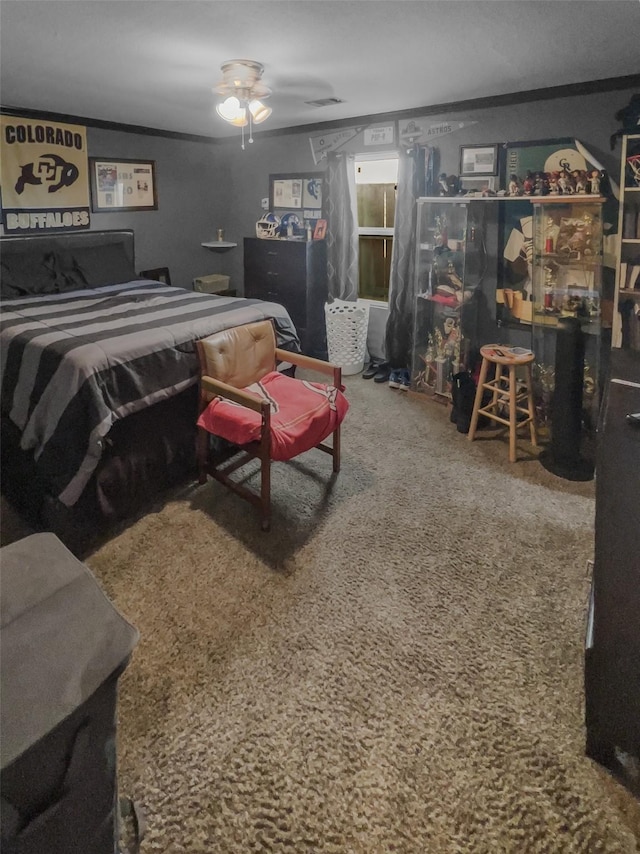 bedroom featuring carpet floors, visible vents, and crown molding