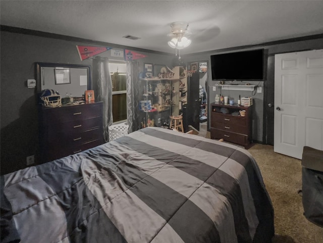 bedroom with a ceiling fan, visible vents, and carpet flooring