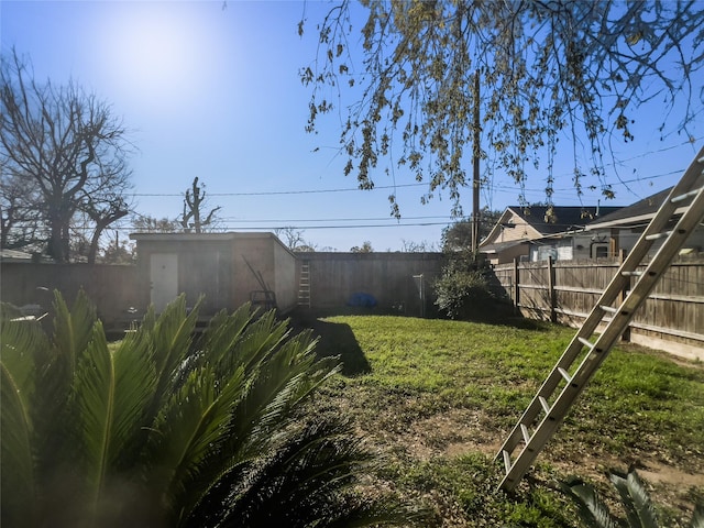 view of yard with a fenced backyard and an outdoor structure