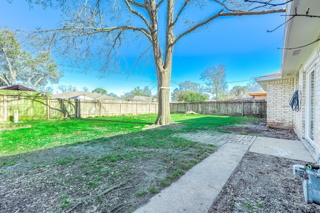 view of yard featuring a patio area and a fenced backyard