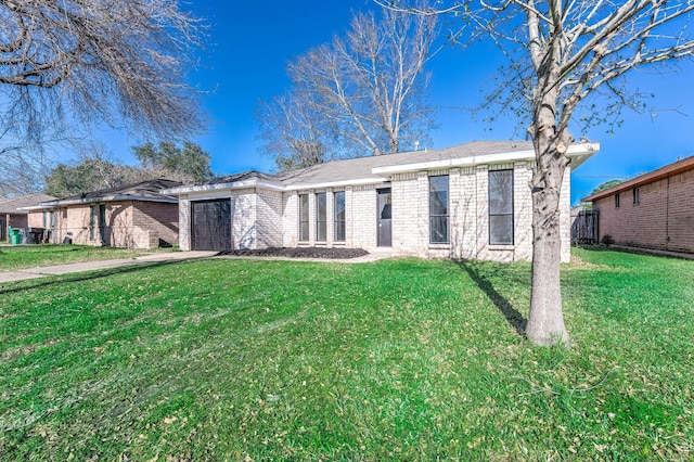 single story home featuring a garage, a front lawn, and brick siding