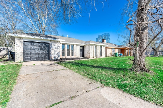 ranch-style house featuring brick siding, a chimney, concrete driveway, a garage, and a front lawn