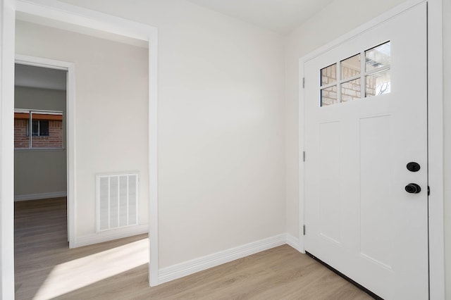 entrance foyer featuring light wood-style flooring, visible vents, and baseboards