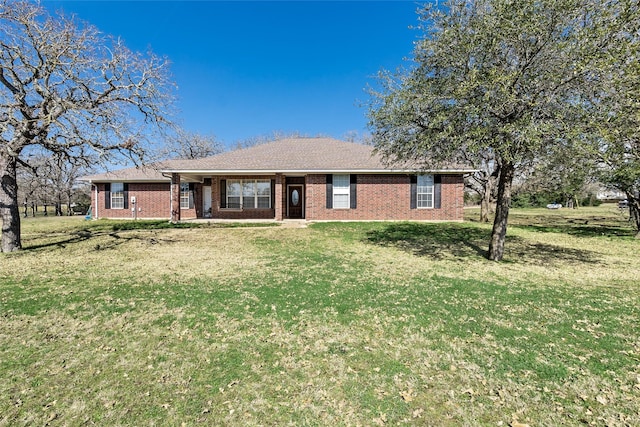 ranch-style house featuring brick siding and a front yard