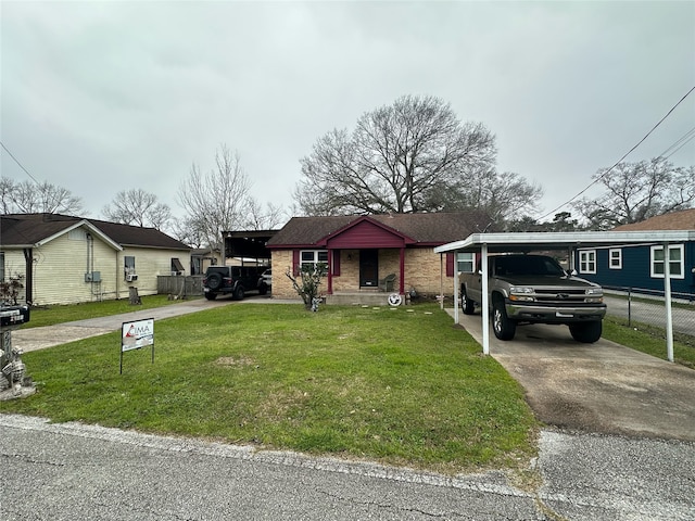 bungalow featuring an attached carport, a front lawn, brick siding, and aphalt driveway