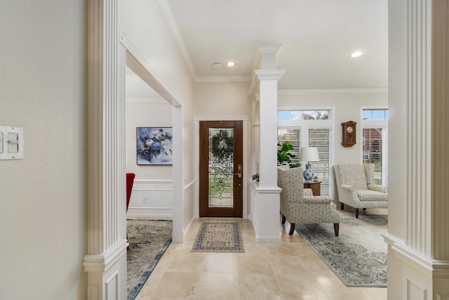 entrance foyer with crown molding, recessed lighting, light tile patterned flooring, and decorative columns