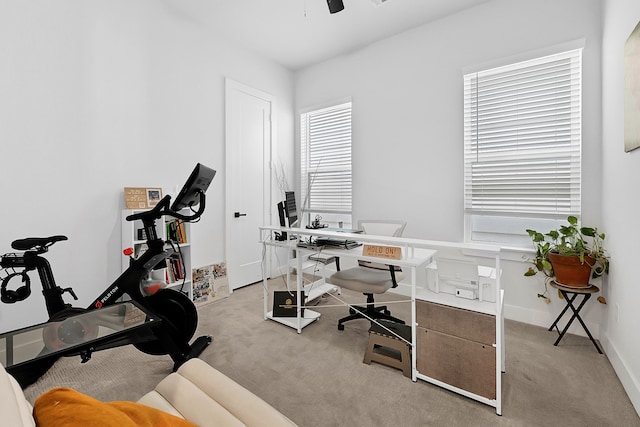 office with light carpet, a ceiling fan, and baseboards