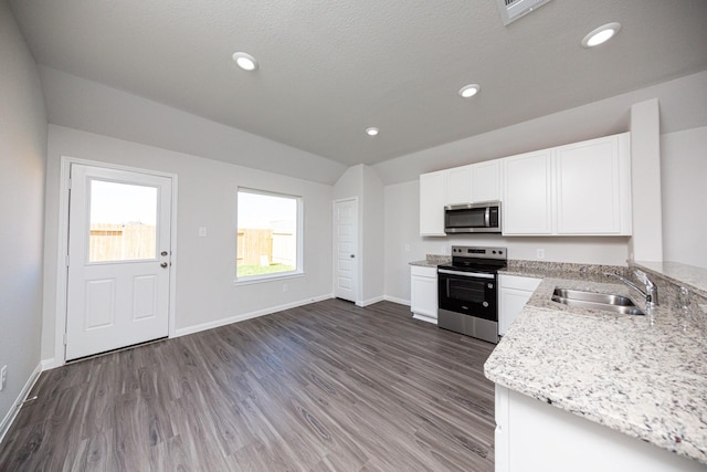 8106 Vanilla Orchid Dr, Houston, TX 77016 - kitchen with white cabinets, baseboards, a sink, appliances with stainless steel finishes, and light stone countertops