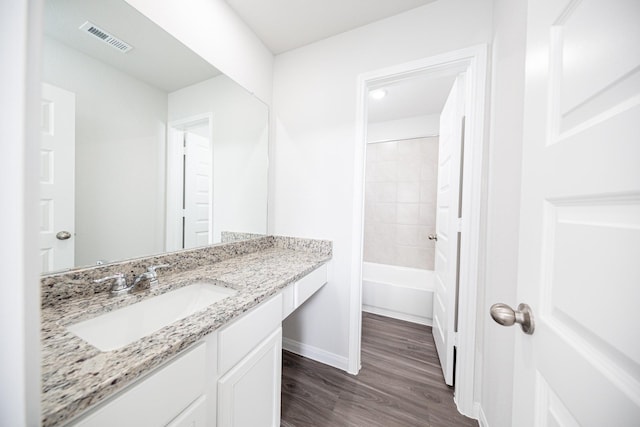 8106 Vanilla Orchid Dr, Houston, TX 77016 - bathroom with visible vents, baseboards, vanity, and wood finished floors