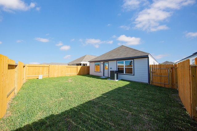 8106 Vanilla Orchid Dr, Houston, TX 77016 - rear view of house featuring central air condition unit, a fenced backyard, and a lawn