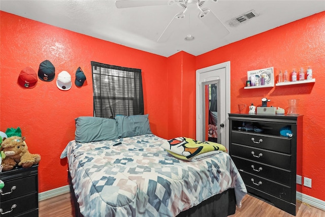 bedroom featuring light wood-type flooring, baseboards, and visible vents