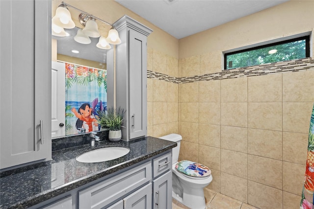 bathroom with tile patterned flooring, vanity, and toilet