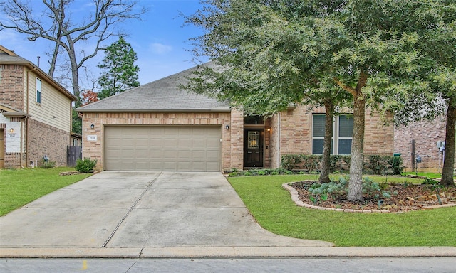 view of front of home featuring driveway, a garage, a front lawn, and brick siding