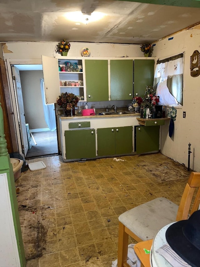 kitchen with open shelves, green cabinets, a sink, and tile patterned floors