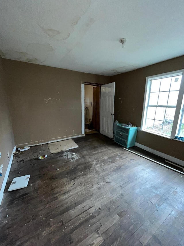 unfurnished bedroom featuring dark wood-type flooring