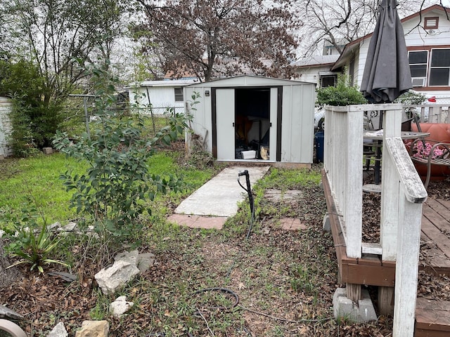 view of yard with an outbuilding, a shed, and fence