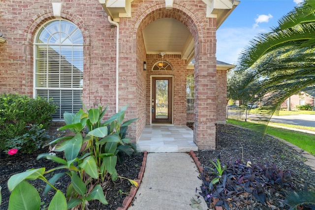 entrance to property featuring brick siding