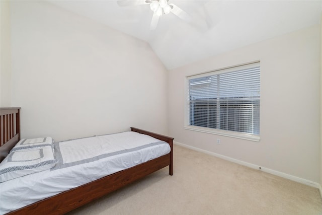 bedroom featuring lofted ceiling, light colored carpet, ceiling fan, and baseboards