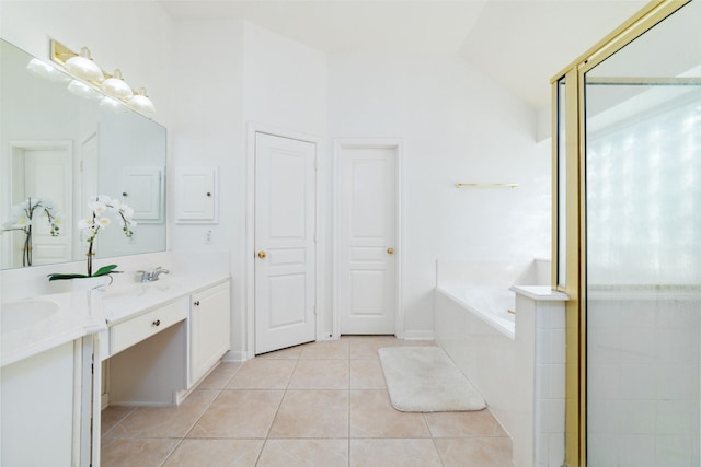 full bathroom featuring lofted ceiling, a garden tub, tile patterned flooring, and double vanity