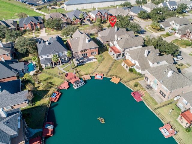 bird's eye view featuring a residential view and a water view