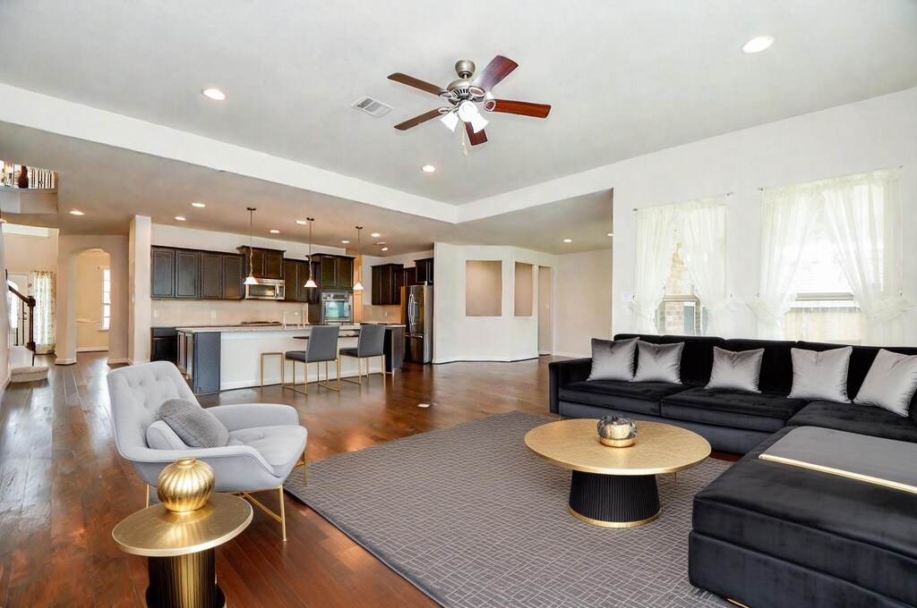 4311 Bay Wind Ct, Katy, TX 77494 - living area featuring visible vents, a ceiling fan, stairway, dark wood-type flooring, and recessed lighting