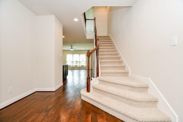 stairs with recessed lighting, wood finished floors, and baseboards