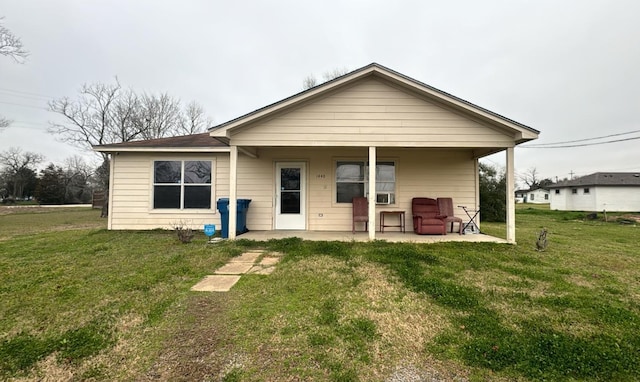 back of property with a lawn, a patio area, and cooling unit