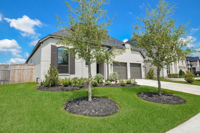 french country home featuring brick siding, fence, concrete driveway, a front yard, and an attached garage