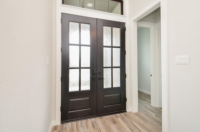 foyer with french doors and wood finished floors