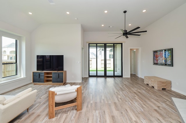 living area with light wood finished floors, recessed lighting, ceiling fan, and vaulted ceiling