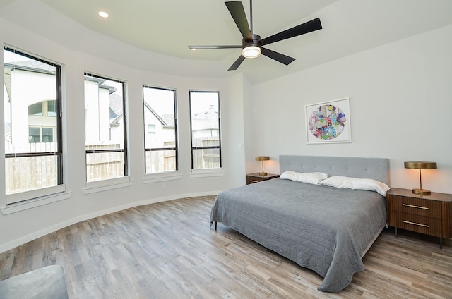 bedroom featuring recessed lighting, wood finished floors, baseboards, and ceiling fan